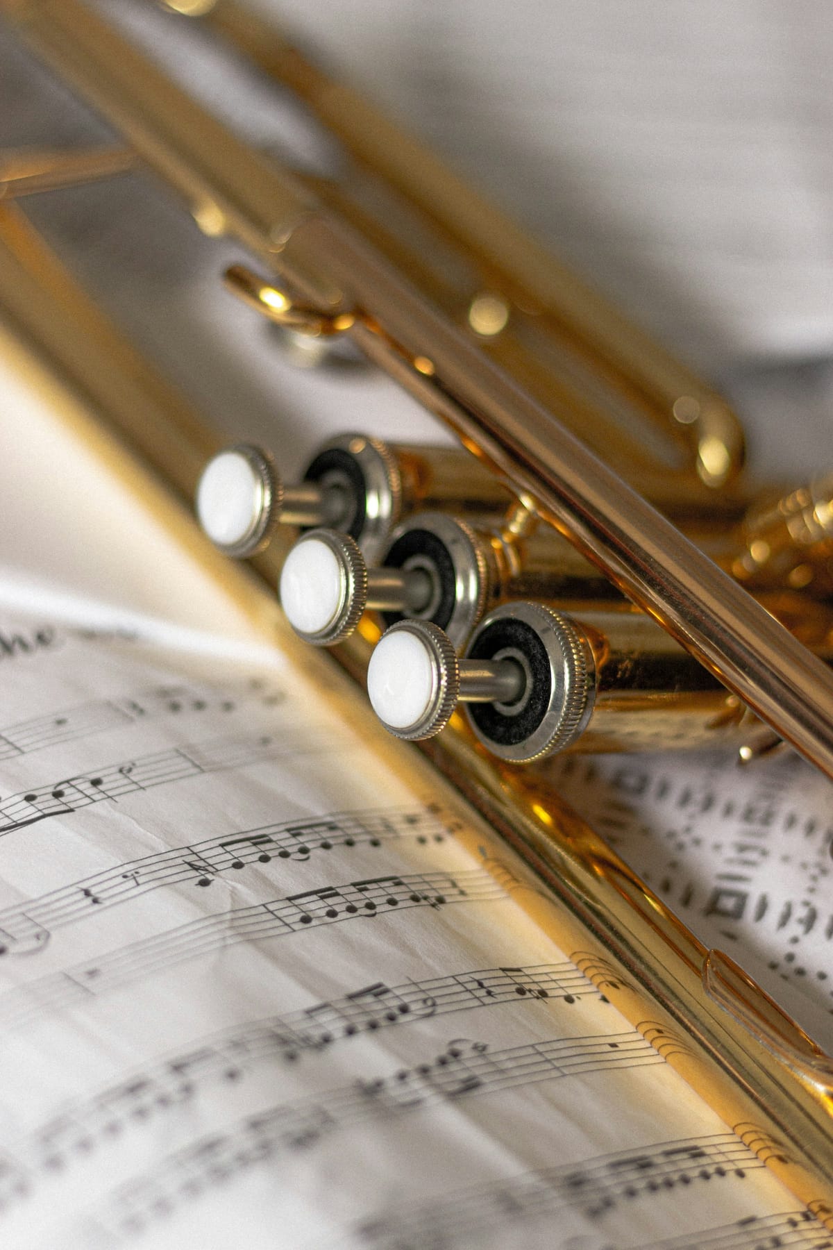 Close detail of brass instrument valves and tubing repeated across the frame