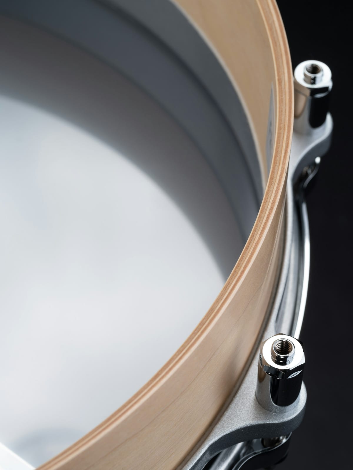 Percussion detail showing a drum shell, rim and tension hardware