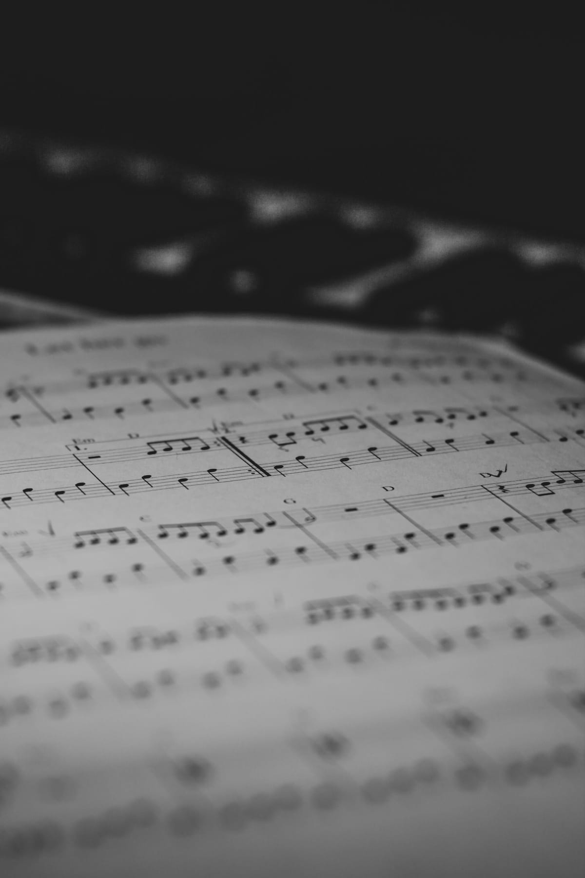 Sheet music resting on a stand in a quiet neutral room, suggesting planning rather than performance