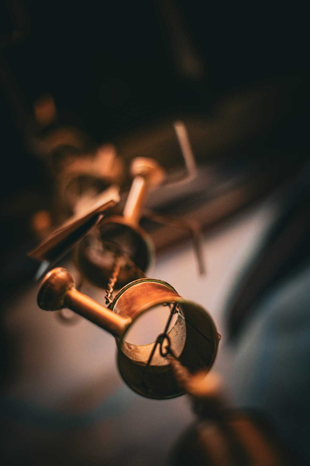 Detail of brass and woodwind instruments arranged on a neutral studio surface